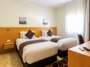伊斯梅利亚弗桑岛美居酒店客房内的一张或多张床位