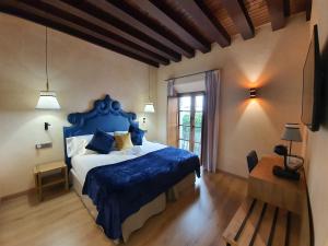 塞维利亚Boutique Puerta Real的一间卧室设有蓝色的床和窗户。