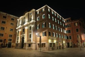 威尼斯布奇托罗酒店的一座晚上有灯的建筑