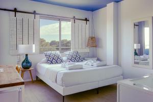 瓦伦西亚YOU & CO. Saler Beach Boutique的白色的卧室设有一张大床和一个窗户