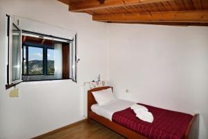 KántanosVilla Areti - A Cottage in the Cretan Nature的一间卧室设有一张床和一个窗口