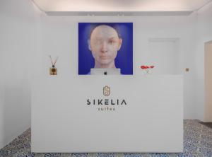诺托Sikelia Suites的墙上挂着一张男人的照片