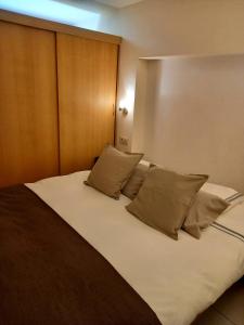 拉罗什-阿登Hebergement confort Comfortlogies La Fontanella的一间卧室配有一张带枕头的大床
