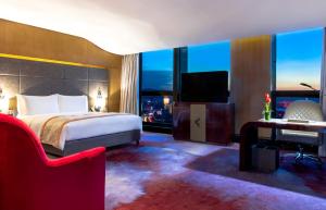 昆明昆明索菲特大酒店的酒店客房配有一张床、一张书桌和一台电视。