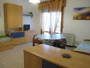 格拉多Argea的一间带桌子的客厅和一间带厨房的房间