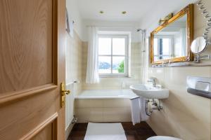 施利尔塞西里亚哲亚霍夫酒店的一间带水槽、浴缸和镜子的浴室