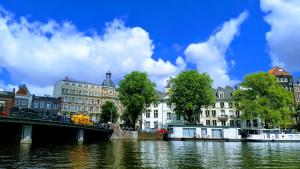 阿姆斯特丹Rembrandt Square Boat的建筑物前的一座河桥