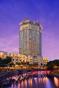 新加坡Grand Copthorne Waterfront的前面有一条河流的大建筑