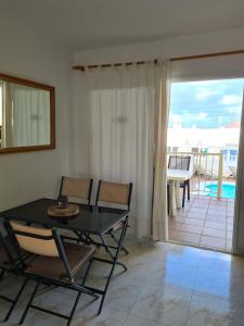 科拉雷侯Villa Majorera的一间带桌椅的客厅和一个阳台