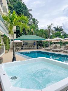 布卢梅瑙Villa do Vale Boutique Hotel的一座棕榈树游泳池和一座建筑