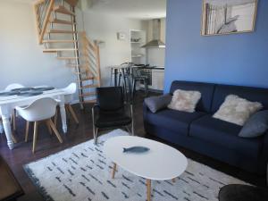波尔特拜Isles Les Ecrehous的客厅配有蓝色的沙发和桌子