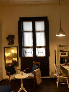 科洛尼亚-德尔萨克拉门托Estudio Taller de Tejas Colonia B&B的客厅设有窗户和桌椅