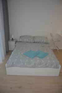 比亚韦斯托克Apartament Royal Place II Jurowiecka 17的一间卧室配有一张带两个蓝色枕头的床