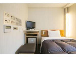 横滨R&B Hotel Shin Yokohama Ekimae - Vacation STAY 14693v的酒店客房设有两张床和电视。