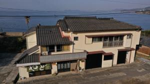 SonogiSaitosyukuba的水边有黑色屋顶的白色房子