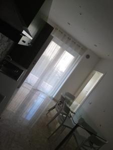 伊塞尔尼亚Suite in Città residence的一间设有玻璃桌和窗户的房间