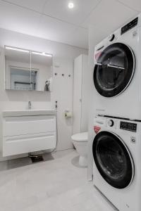 埃斯波Tapiola Oak Apartment的一间带洗衣机和水槽的浴室