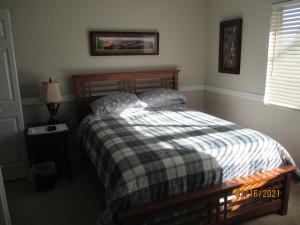 弗拉格斯塔夫Peaks Wildernest House Bed and Breakfast - Vaccinations Required的一间卧室配有一张带 ⁇ 子毯子的床