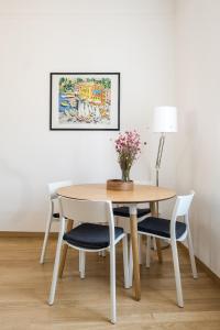 博洛尼亚Canonica Suites的一张桌子和椅子,上面有花瓶