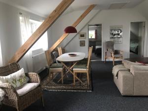 ØlstedStrandsegård Ferielejlighed的客厅配有桌椅