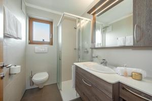圣洛伦佐-迪塞巴托佩奇纳霍夫酒店的一间带水槽、卫生间和镜子的浴室