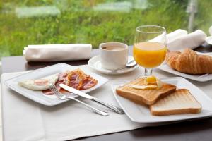 比韦罗拉斯希蕾娜斯酒店的一张桌子,上面放着两盘食物和一杯橙汁