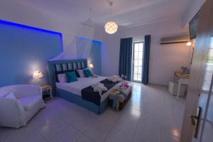 阿林达Saraya Resort的一间卧室配有一张床、一张沙发和一把椅子