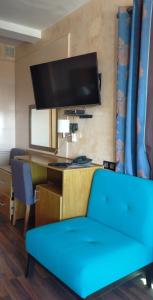 阿加迪尔阿弗德公寓酒店的客厅配有蓝色的沙发和书桌