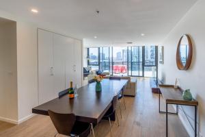 墨尔本Melbourne City Apartments - Teri的用餐室和带大桌子的客厅