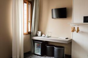 威尼斯卡纳雷吉欧2357酒店的客房设有带2张凳子的壁炉和电视。