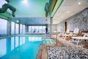 蒂耶里堡法兰西岛贝斯特韦斯特酒店的一座配有桌椅的酒店游泳池