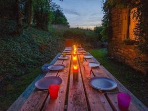 希迈Quaint Holiday Home in Robechies amid Meadows的一张长木桌子,上面有盘子和餐具