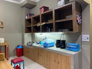 日惹RedDoorz near Gembira Loka Zoo 3的厨房配有木制橱柜和蓝色家电