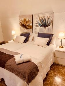 比列纳Casa Jazmín的一间卧室配有两张床和两盏灯。