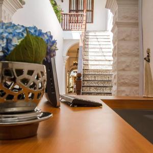 卡塔赫纳圣亚历杭德里亚酒店 的一张桌子,桌子上放着一台笔记本电脑,楼梯上放着