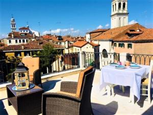威尼斯VENICE HOLIDAY TERRACE的阳台的天井配有桌椅