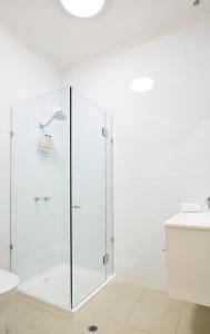 墨尔本索非亚酒店的白色浴室设有玻璃淋浴间