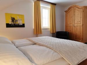 巴德米滕多夫库尔姆乡村别墅的卧室配有白色的床和窗户。