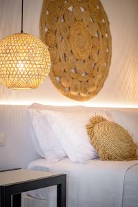 皮尔戈斯Thealos Santorini的一间设有床、一盏灯和一篮子的房间