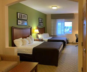 盖茨堡Sleep Inn & Suites Gettysburg的酒店客房,设有两张床和一张沙发