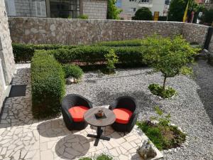 杜布罗夫尼克角落公寓的花园内带两把椅子和一张桌子的庭院