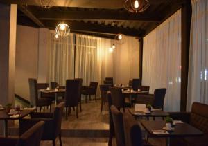 帕丘卡德索托ESDUMA HK HOTEL Pachuca的用餐室配有桌椅和灯光