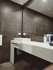 阿波罗湾ODYSSEY APOLLO BAY的浴室设有白色水槽和镜子