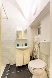 布拉索夫Piata Sfatului Central的浴室配有白色卫生间和盥洗盆。