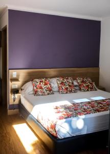 麦德林Hotel Poma Rosa的一间卧室配有一张大床和枕头