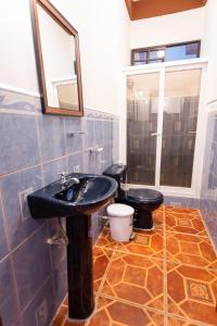 科马亚瓜APARTAMENTOS CASCO HISTORICO COMAYAGUA的一间带黑色水槽和卫生间的浴室