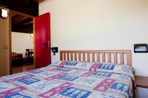 帕苏德尔托纳莱萨沃依公寓的一间卧室,床上有五颜六色的被子