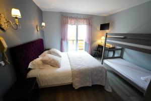 圣雅克·德波尔Logis Hôtel Le Griou的一间卧室设有一张床和一个窗口