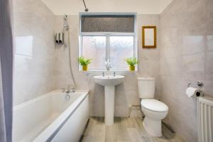 伯明翰Wray And Whyte House的浴室配有盥洗盆、卫生间和浴缸。