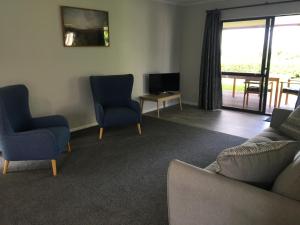 陶朗加Te Harinui - Peaceful rural escape的客厅配有沙发、椅子和电视